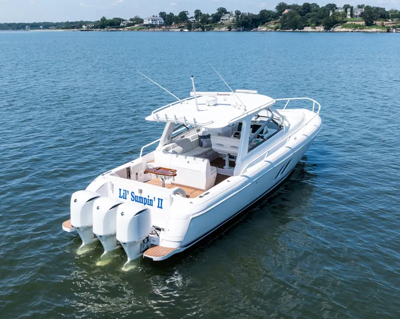 Slide: The Image of 2015 Intrepid 430 Sport Yacht on calm water, rear view with triple engines. - 1