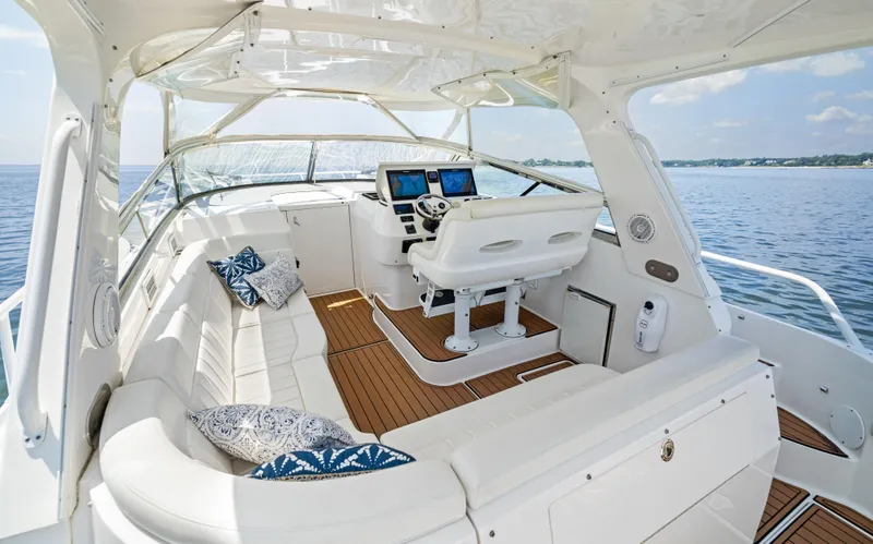 Slide: The Image of 2015 Intrepid 430 Sport Yacht interior with plush seating and modern navigation system. - 11