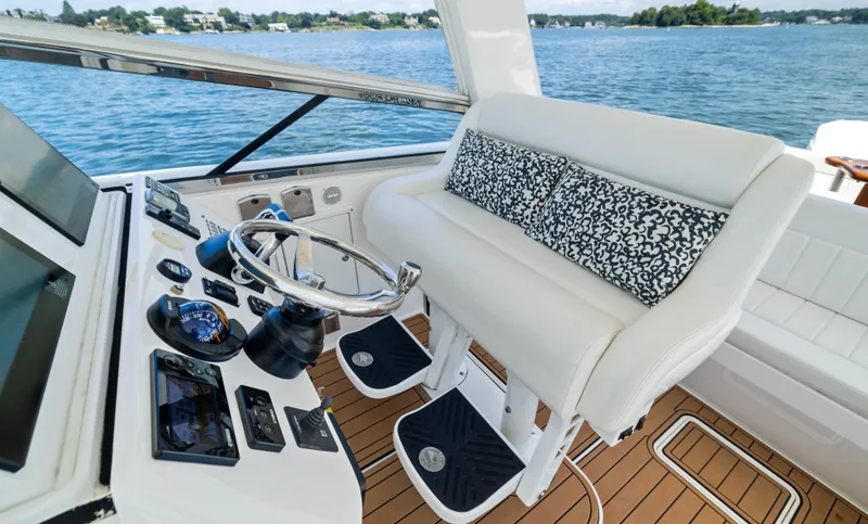 Slide: The Image of 2015 Intrepid 430 Sport Yacht helm with white seating and ocean view. - 12