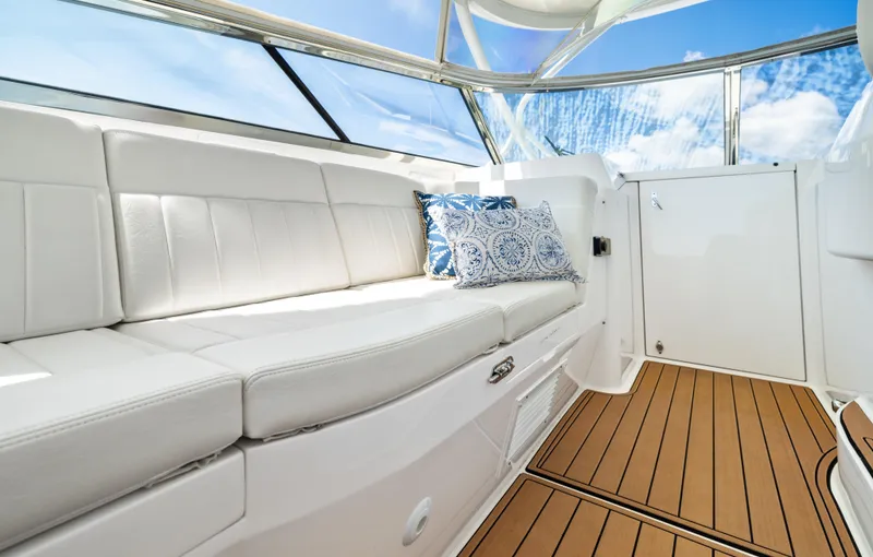 Slide: The Image of Luxurious interior of 2015 Intrepid 430 Sport Yacht with white seating and decorative pillows. - 14