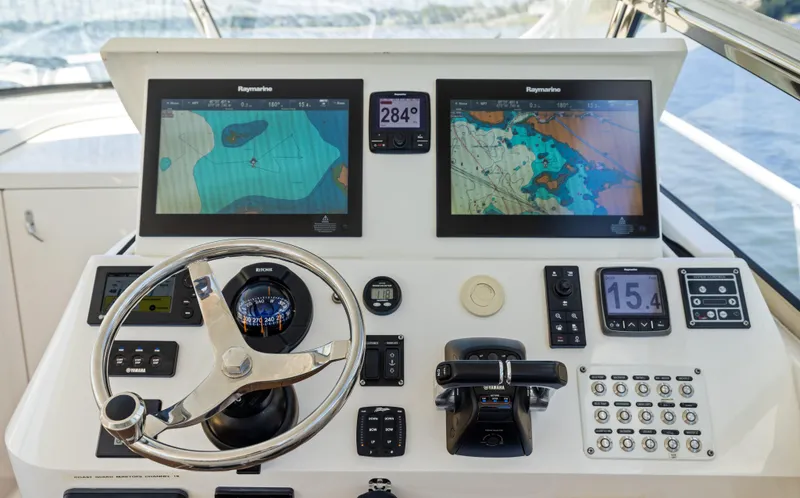 Slide: The Image of Control panel of a 2015 Intrepid 430 Sport Yacht with navigation screens and steering wheel. - 15