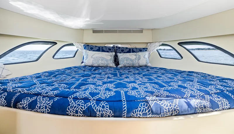 Slide: The Image of Luxurious cabin interior of 2015 Intrepid 430 Sport Yacht with nautical-themed bedding. - 19