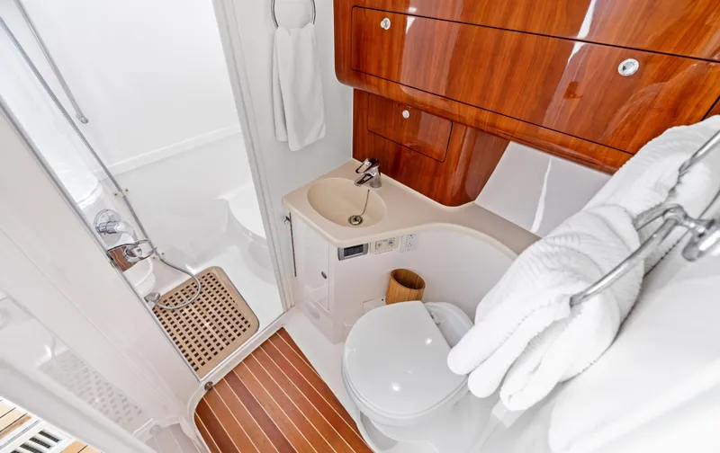 Slide: The Image of Luxurious bathroom in 2015 Intrepid 430 Sport Yacht with wood accents and modern fixtures. - 21