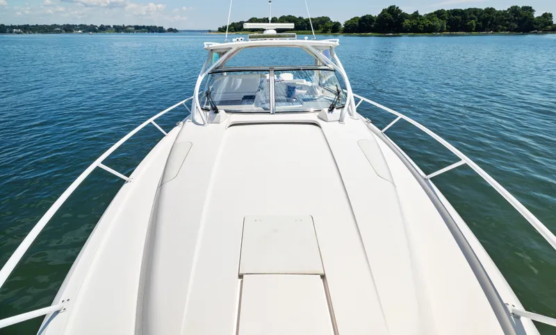 Slide: The Image of 2015 Intrepid 430 Sport Yacht on calm water, showcasing sleek deck design. - 7
