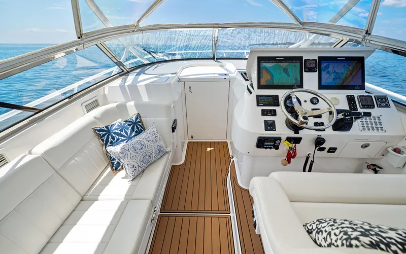 Slide: The Image of 2015 Intrepid 430 Sport Yacht cockpit with plush seating and advanced navigation systems. - 9
