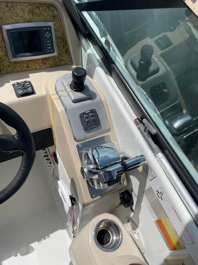 Slide: The Image of Control panel of a 2010 Formula 350ss boat with steering wheel and throttle. - 10