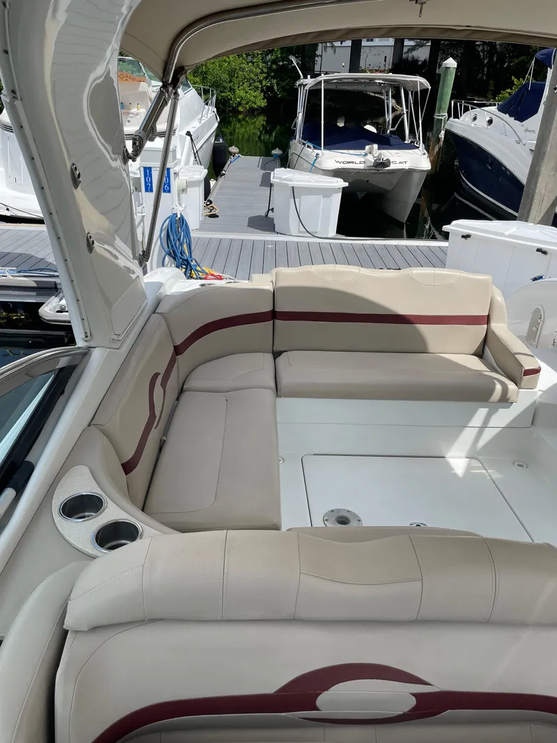 Slide: The Image of 2010 Formula 350ss boat interior with beige seating and cup holders at a marina. - 12