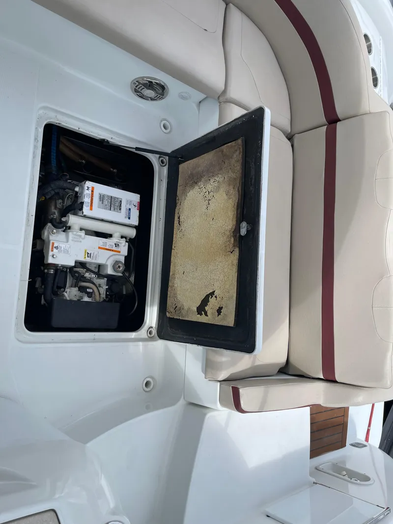 Slide: The Image of Open engine compartment of a 2010 Formula 350ss boat with seating area. - 21