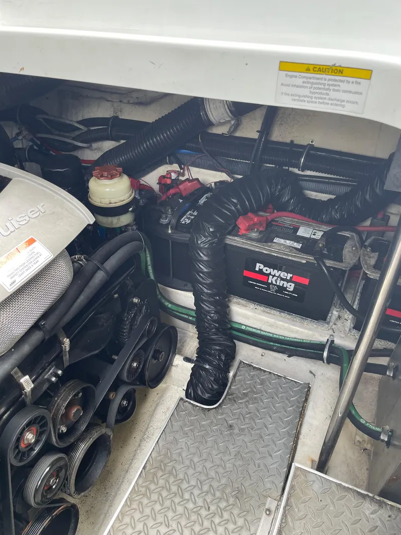 Slide: The Image of Engine compartment of a 2010 Formula 350ss boat with visible battery and components. - 26