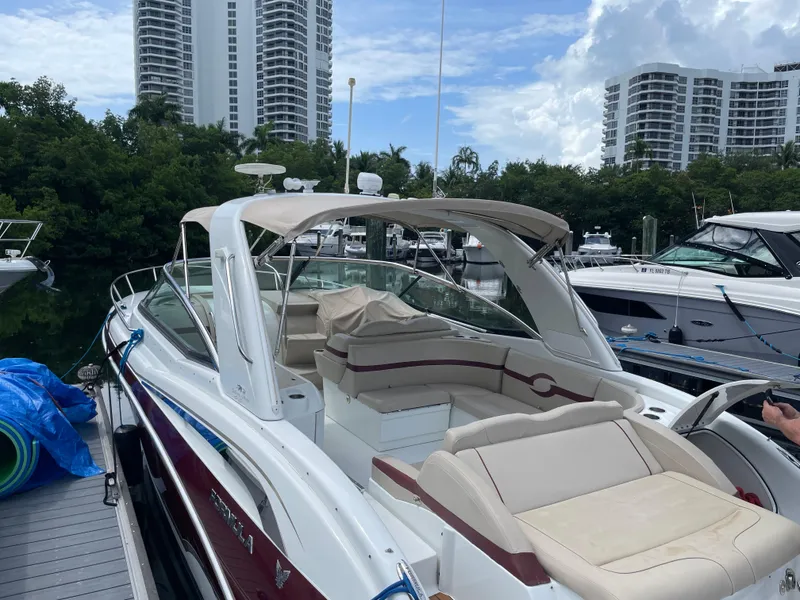 Slide: The Image of 2010 Formula 350ss boat docked, surrounded by modern buildings and lush greenery. - 3