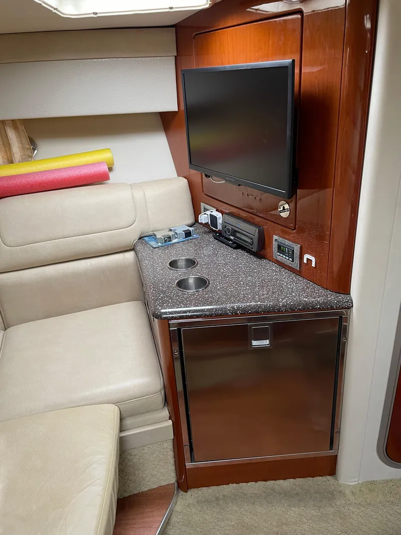 Slide: The Image of Interior of a 2010 Formula 350ss boat with TV, seating, and kitchenette. - 33