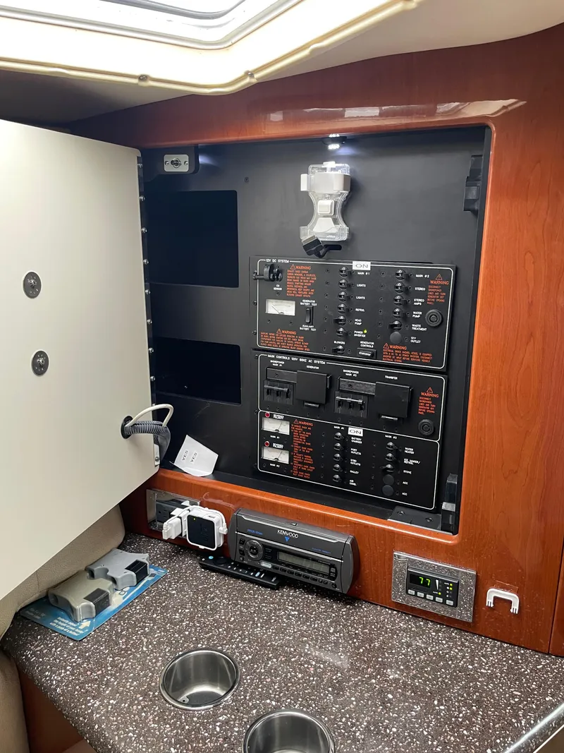 Slide: The Image of Control panel inside a 2010 Formula 350ss boat, featuring switches and electronic devices. - 34