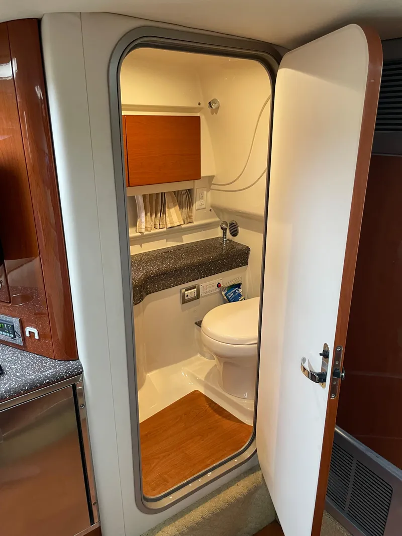 Slide: The Image of 2010 Formula 350ss boat bathroom with modern fixtures and wood accents. - 38