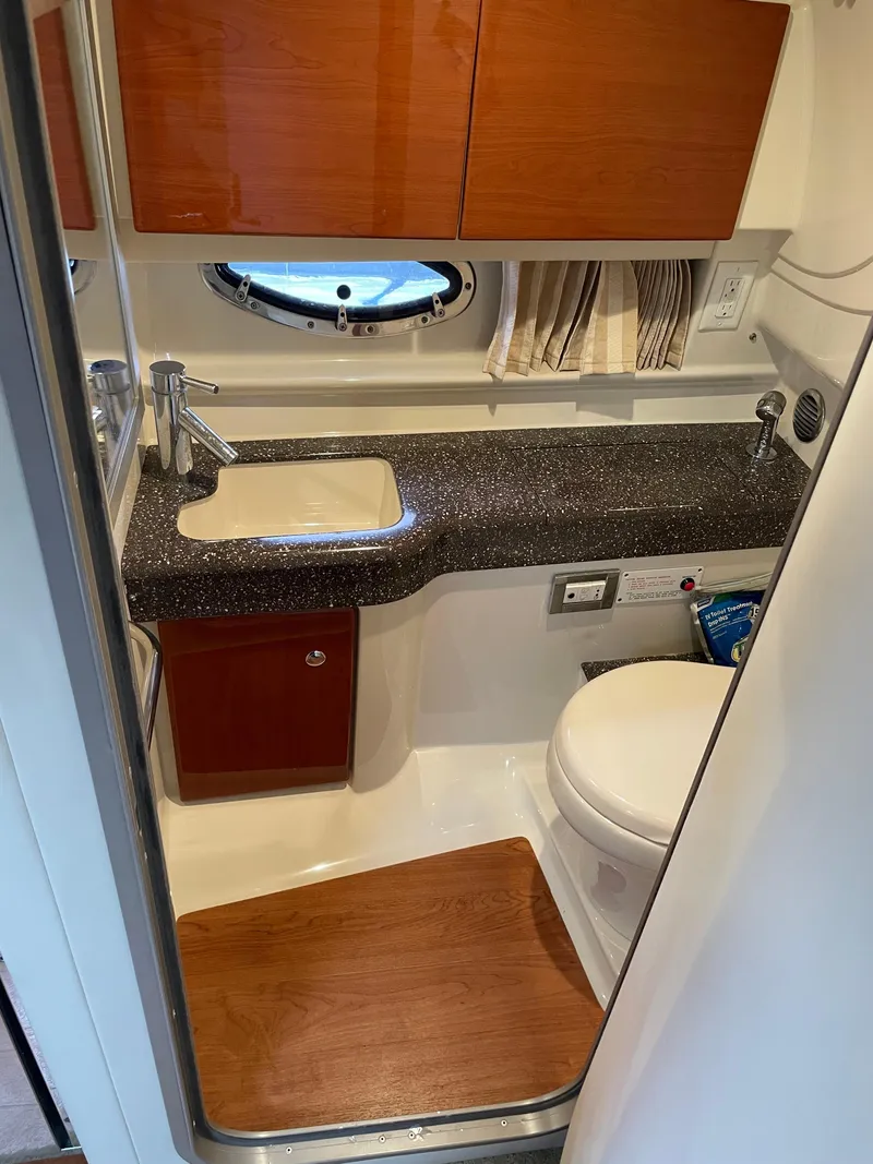 Slide: The Image of 2010 Formula 350ss boat bathroom with sink, toilet, and wood accents. - 39