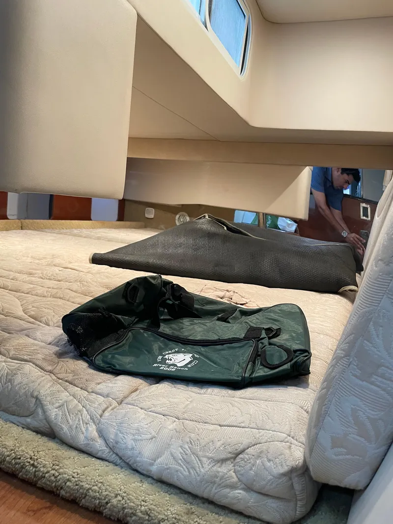 Slide: The Image of Interior cabin of a 2010 Formula 350ss boat with bedding and bags. - 40