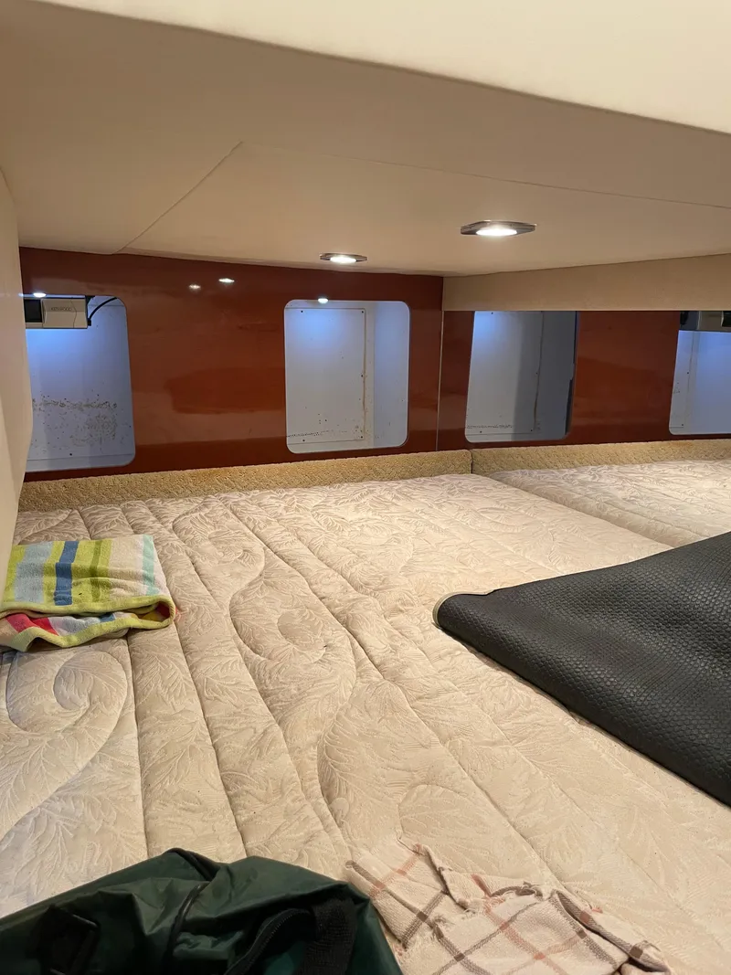 Slide: The Image of Interior cabin of a 2010 Formula 350ss boat with cozy bedding and ambient lighting. - 41