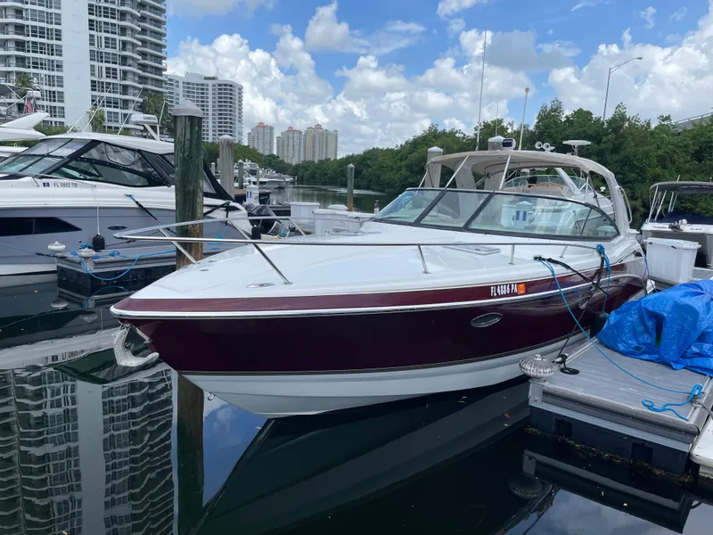 Slide: The Image of 2010 Formula 350ss boat docked at marina, surrounded by other boats and buildings. - 43