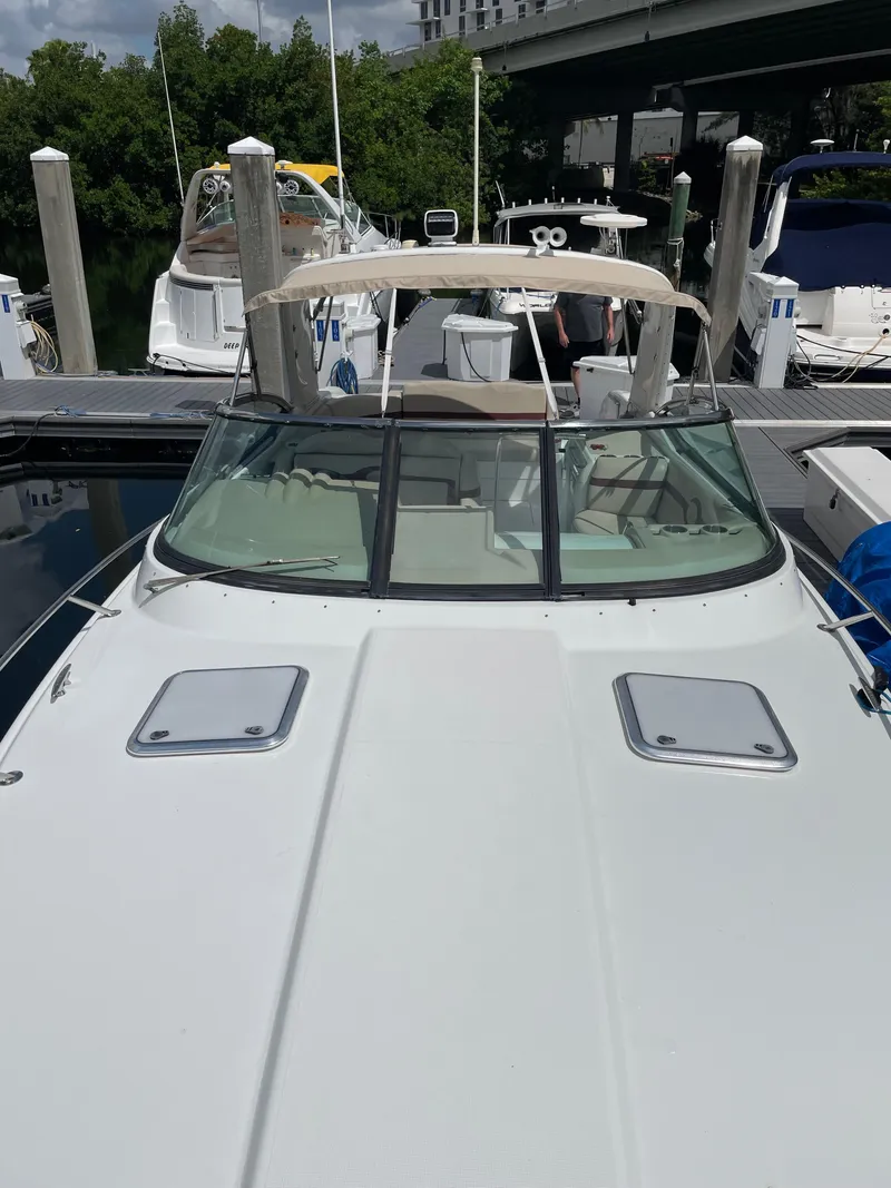 Slide: The Image of 2010 Formula 350ss boat docked at marina, featuring sleek design and spacious deck. - 45