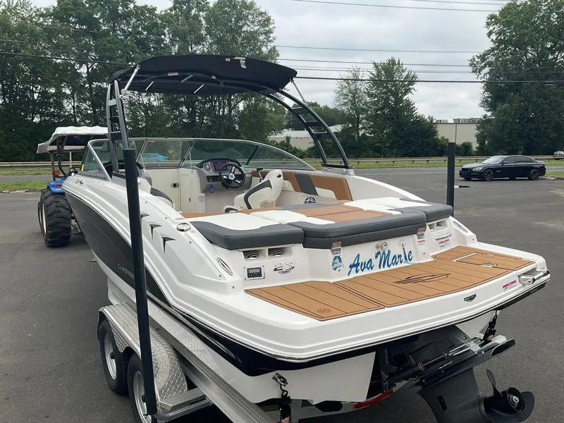 Slide: The Image of 2023 Chaparral 23 SSi boat on trailer, featuring sleek design and modern interior. - 1
