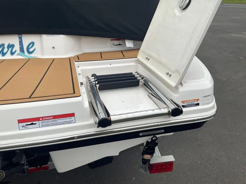 Slide: The Image of 2023 Chaparral 23 SSi boat with open swim platform ladder and safety warnings. - 10