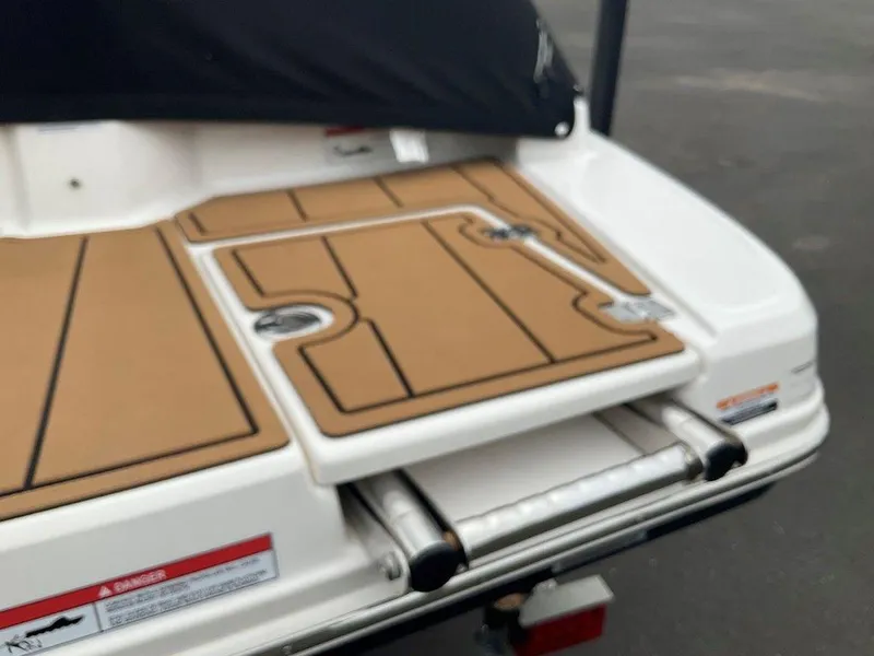 Slide: The Image of 2023 Chaparral 23 SSi boat swim platform with teak-style decking and retractable ladder. - 11