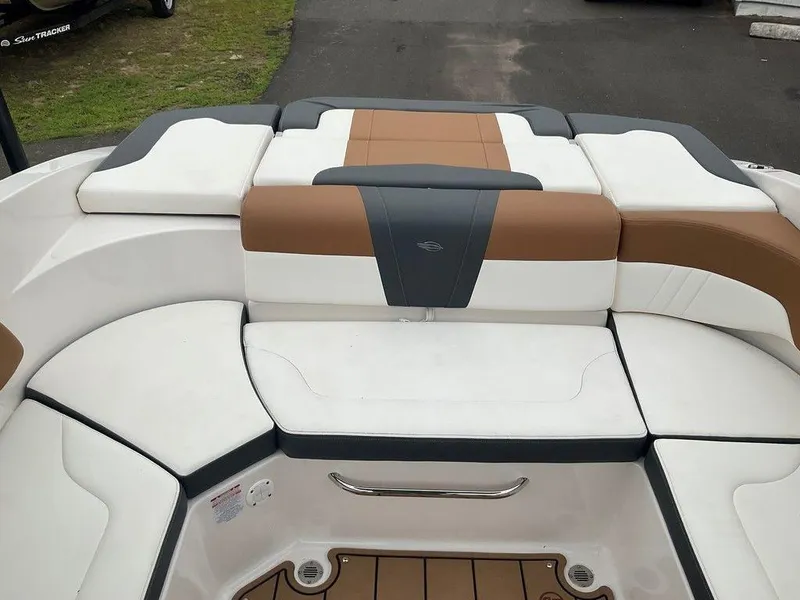 Slide: The Image of 2023 Chaparral 23 SSi boat interior with white and brown cushioned seating. - 15