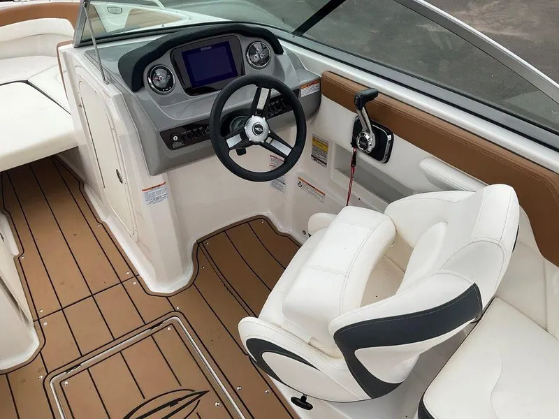 Slide: The Image of 2023 Chaparral 23 SSi boat interior with steering wheel, dashboard, and seating. - 20