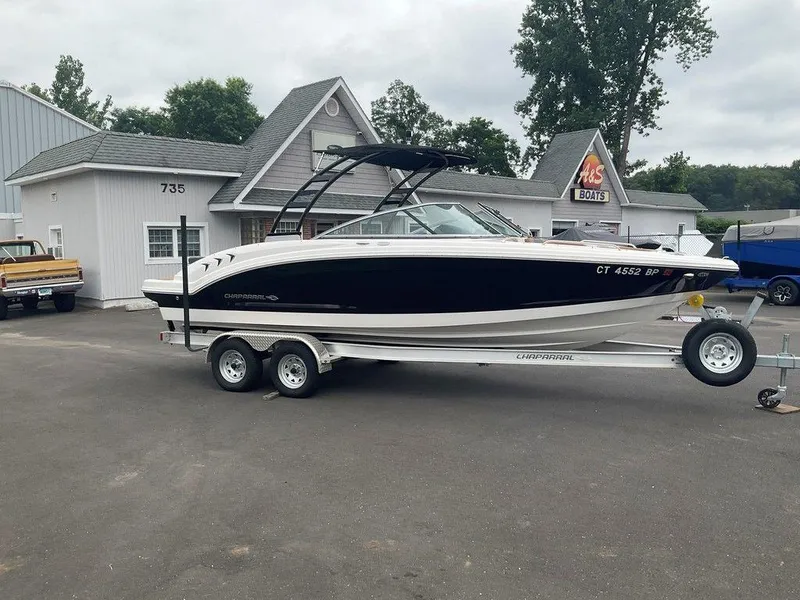 Slide: The Image of 2023 Chaparral 23 SSi boat on trailer outside dealership, showcasing sleek design. - 3
