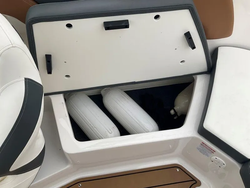 Slide: The Image of 2023 Chaparral 23 SSi boat storage compartment with fenders and equipment. - 30