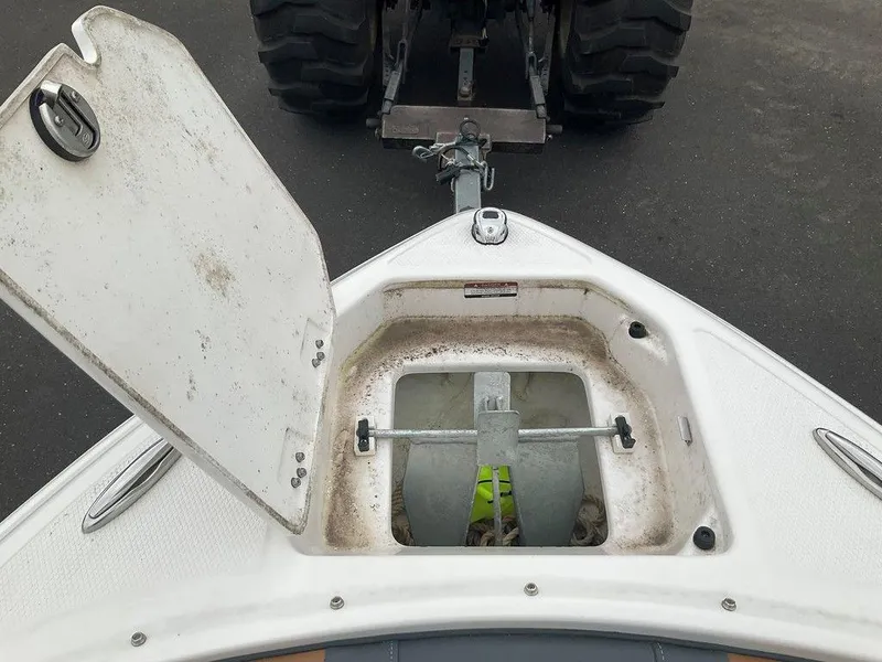 Slide: The Image of Open anchor compartment on 2023 Chaparral 23 SSi boat, showing anchor and rope storage. - 35