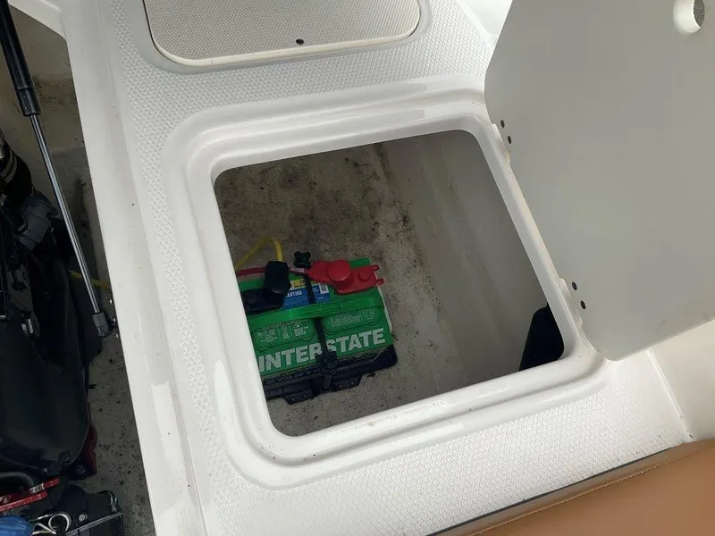 Slide: The Image of Battery compartment of 2023 Chaparral 23 SSi boat with Interstate battery visible. - 40