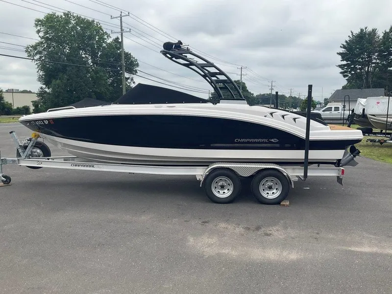 Slide: The Image of 2023 Chaparral 23 SSi boat on trailer, parked outdoors on a cloudy day. - 5