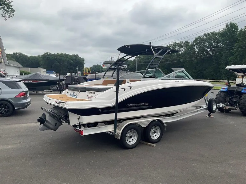 Slide: The Image of 2023 Chaparral 23 SSi boat on trailer, parked outdoors, overcast sky. - 7