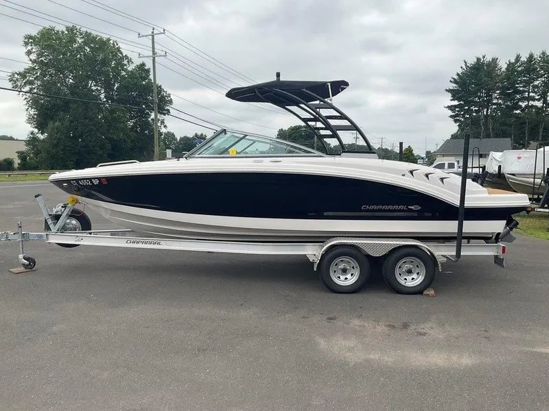 Slide: The Image of 2023 Chaparral 23 SSi boat on trailer, parked outdoors, overcast sky. - 8