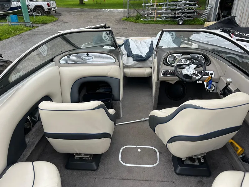 Slide: The Image of 2007 Malibu Wakesetter 247 LSV interior with beige seating and modern dashboard. - 9