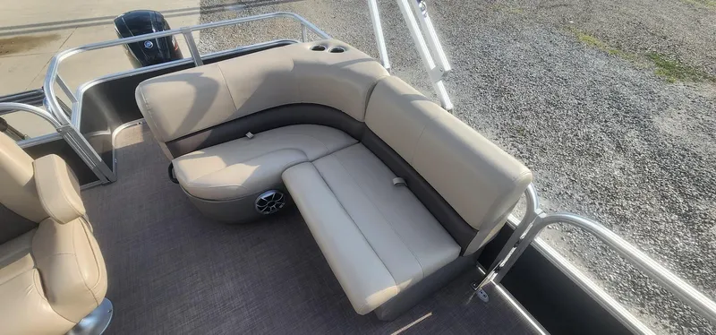 Slide: The Image of 2024 Sun Tracker Party Barge 18 DLX interior with beige seating and speaker system. - 14