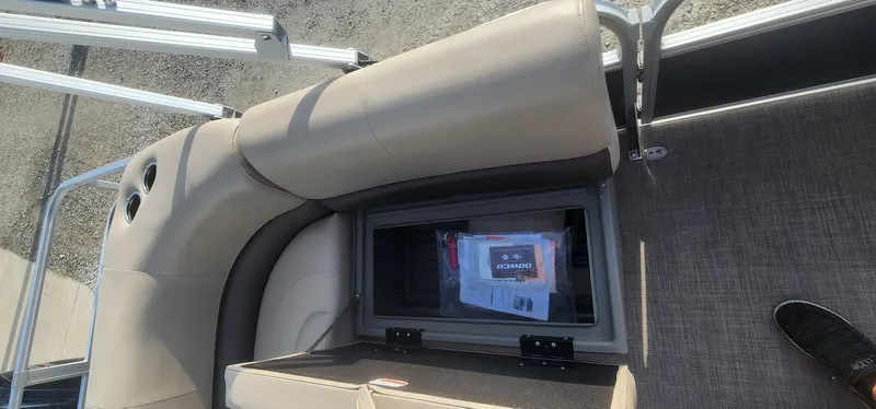 Slide: The Image of 2024 Sun Tracker Party Barge 18 DLX storage compartment with manuals and accessories. - 15