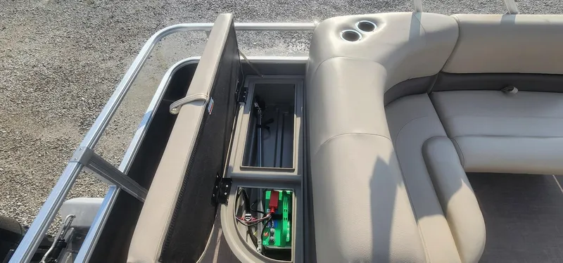 Slide: The Image of 2024 Sun Tracker Party Barge 18 DLX with open storage compartment and seating. - 18
