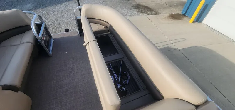 Slide: The Image of 2024 Sun Tracker Party Barge 18 DLX interior with beige seating and storage compartments. - 8