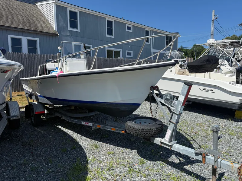 Slide: The Image of 1998 C-Hawk 18 boat on trailer, parked on gravel near a house. - 11