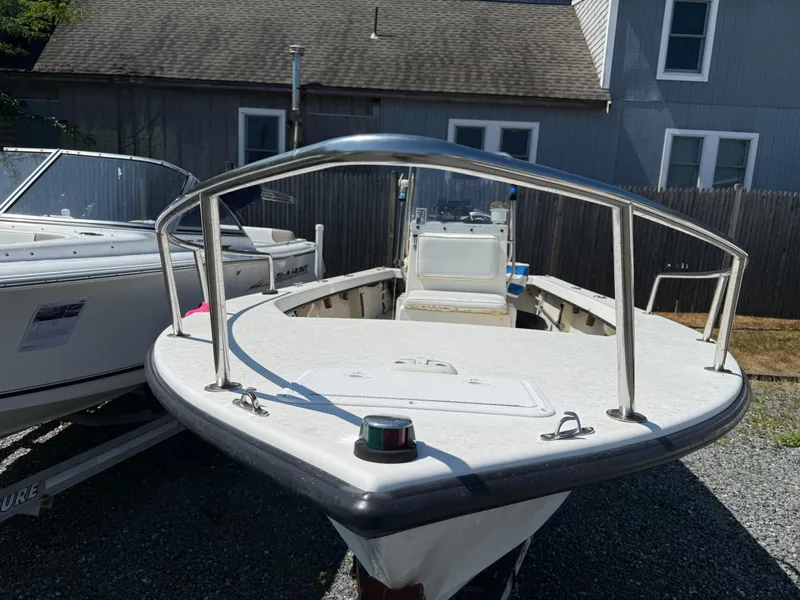 Slide: The Image of 1998 C-Hawk 18 boat with white deck and railing, parked outdoors. - 4