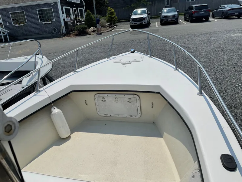 Slide: The Image of 1998 C-Hawk 18 boat bow view in parking lot, featuring clean deck and railing. - 5