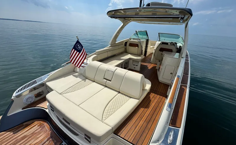 Slide: The Image of 2022 Chris-Craft Launch 35 GT I/O Heritage Edition on calm water, featuring luxurious seating and wood accents. - 10