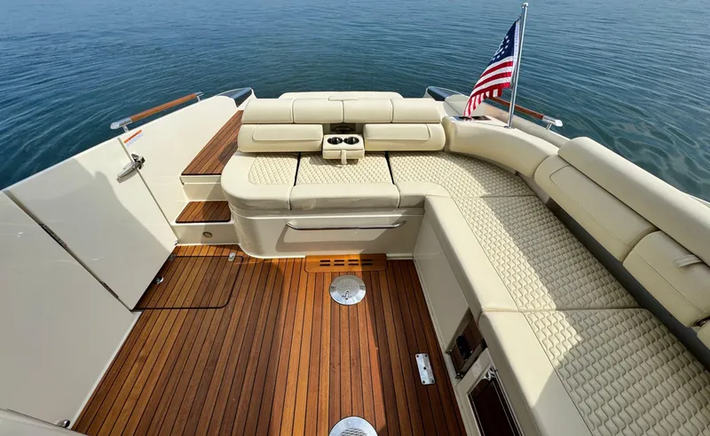 Slide: The Image of Luxurious 2022 Chris-Craft Launch 35 GT I/O Heritage Edition boat interior with elegant seating and wooden deck. - 11