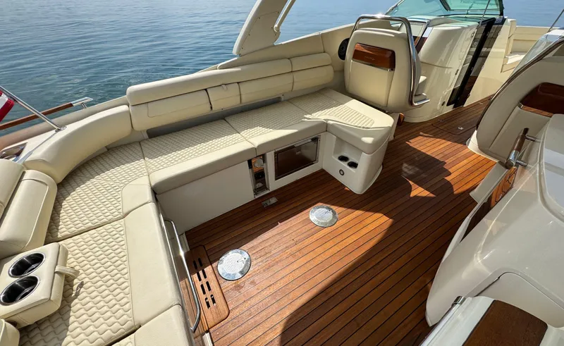 Slide: The Image of 2022 Chris-Craft Launch 35 GT I/O Heritage Edition boat interior with luxurious seating and wooden deck. - 13