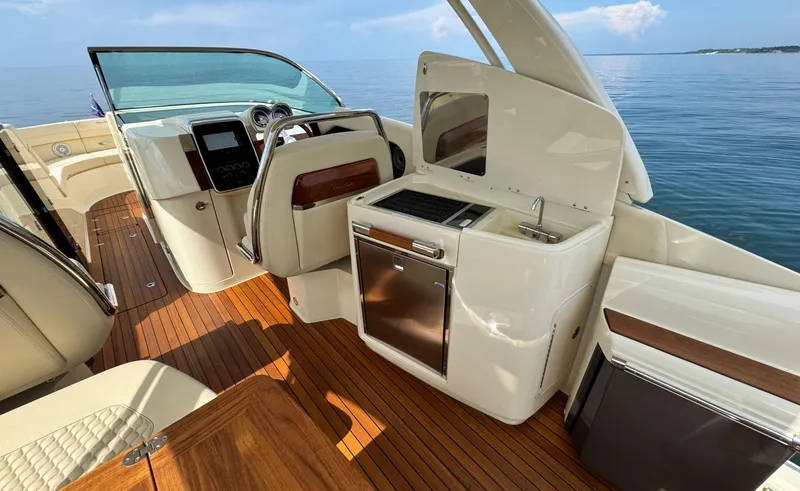 Slide: The Image of 2022 Chris-Craft Launch 35 GT I/O Heritage Edition boat interior with elegant wood finish. - 18