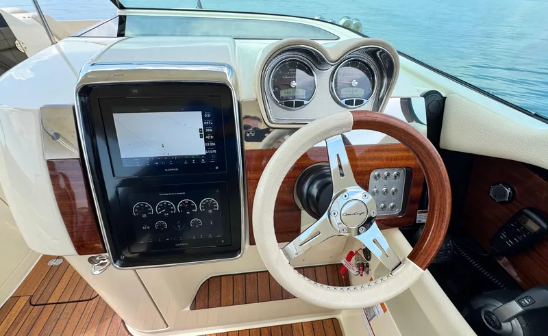 Slide: The Image of 2022 Chris-Craft Launch 35 GT I/O Heritage Edition dashboard with steering wheel and navigation display. - 21