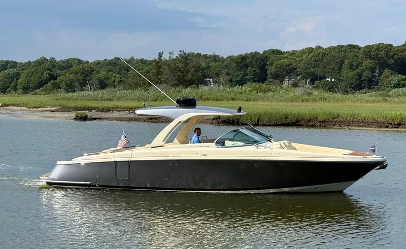 Slide: The Image of 2022 Chris-Craft Launch 35 GT I/O Heritage Edition cruising on a serene river. - 3