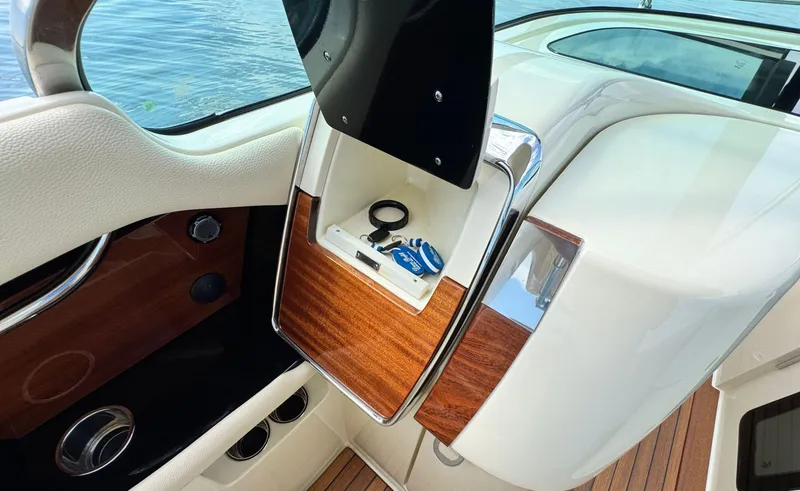 Slide: The Image of 2022 Chris-Craft Launch 35 GT I/O Heritage Edition interior with wood accents and storage compartment. - 31