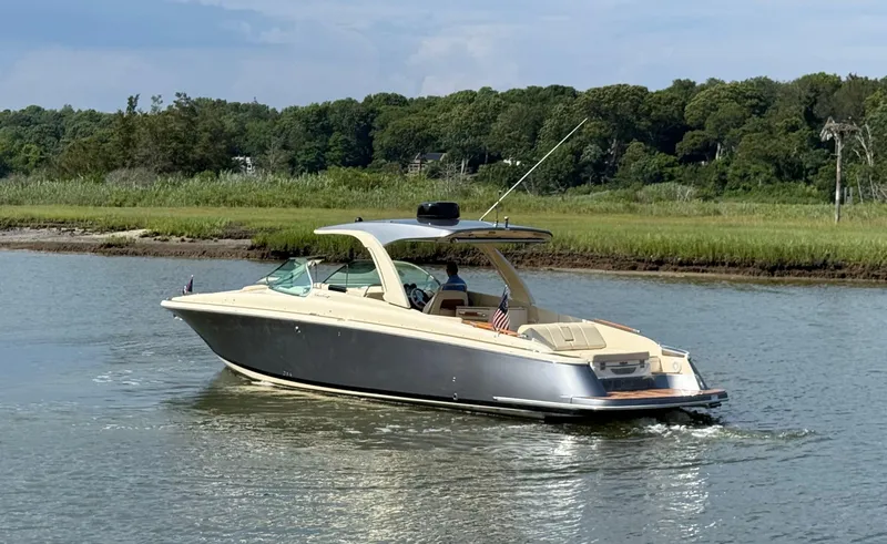 Slide: The Image of 2022 Chris-Craft Launch 35 GT I/O Heritage Edition cruising on a serene waterway. - 7